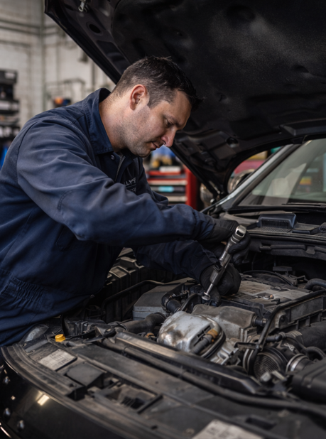 Mechanic working on vehicle engine repair at Billy's Automotive workshop Newcastle upon Tyne